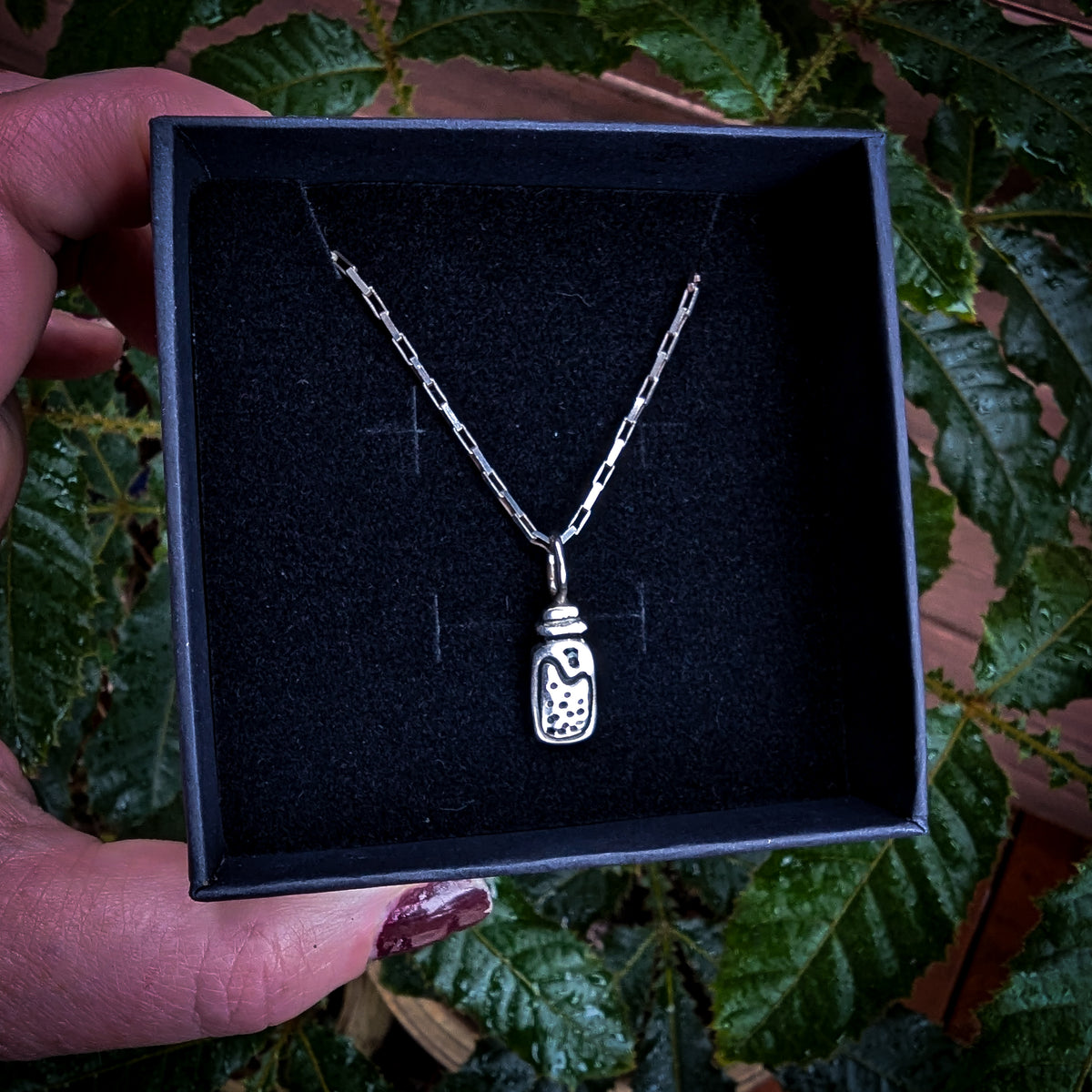 Fine silver potion bottle on vintage sterling chain