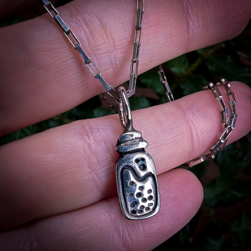 Fine silver potion bottle on vintage sterling chain
